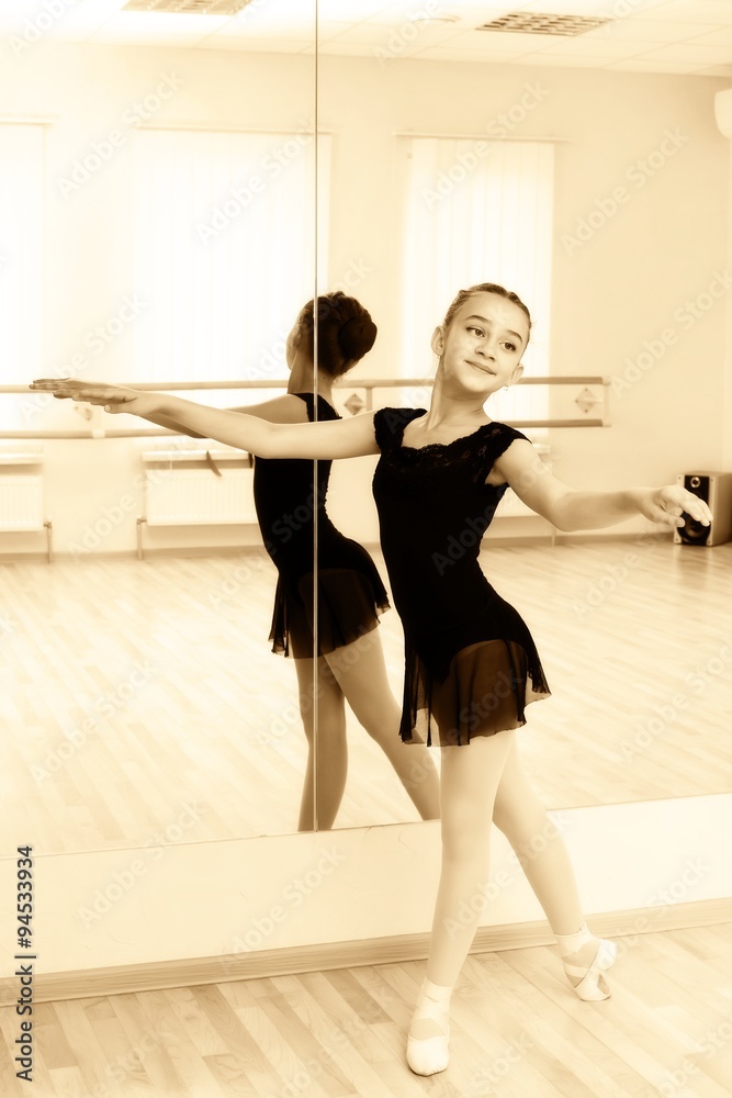 Obraz premium a little girl dressed as a ballerina in ballet