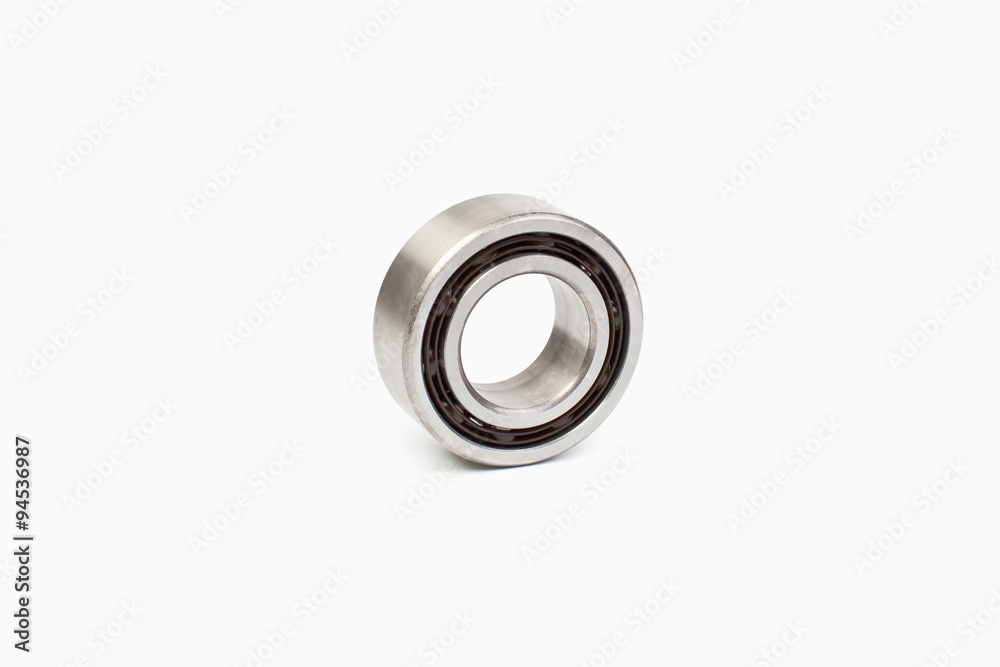 Close-up bearings spare part of mechanical on the white background. Close-up bearings spare part of mechanical on the white background.