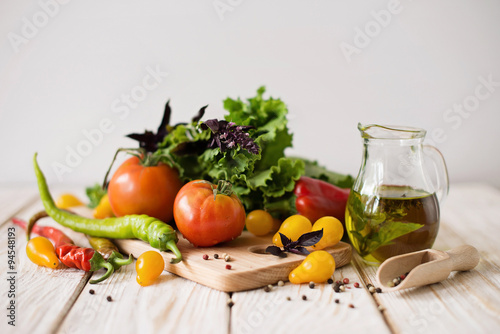 Composition with vegetables and spices on a table on a white background