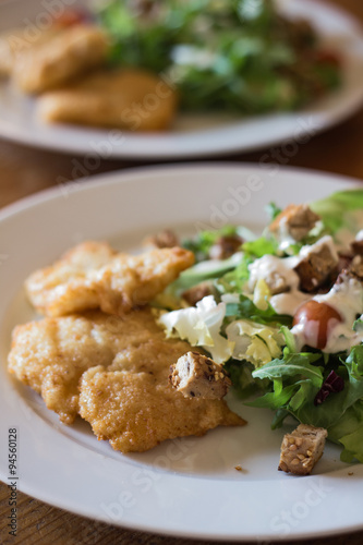 Fried fish with Caesar salad.
