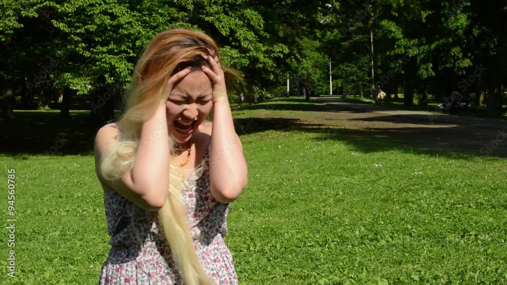 young attractive asian woman shouts in the park young attractive asian woman shouts in the park