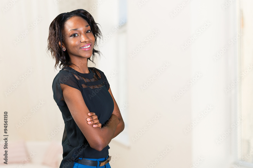 Happy young african woman standing with arms crossed Happy young african woman standing with arms crossed