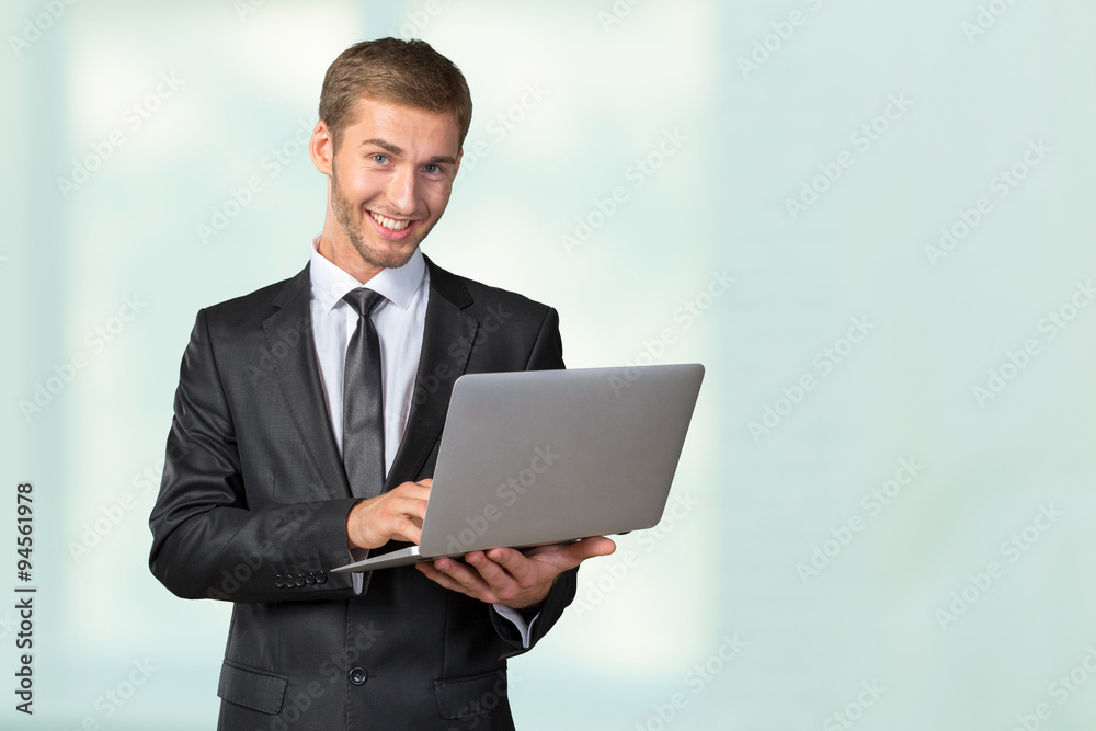 Young handsome businessman holding laptop Young handsome businessman holding laptop