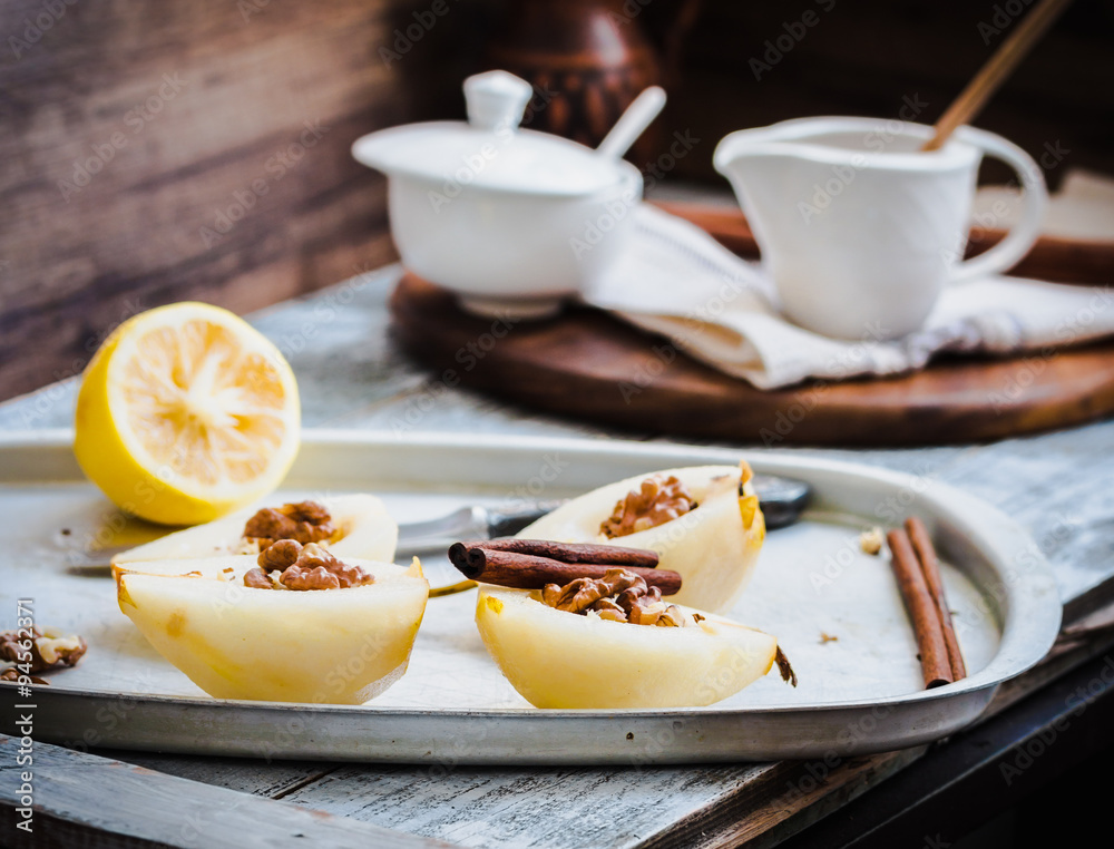 Fototapeta premium cooking process pear with walnuts, cinnamon sticks on an iron pl