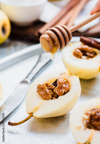 pear with walnuts and honey before baking, cinnamon sticks
