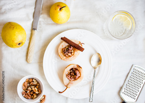 spicy baked pear with walnuts, honey, healthy dessert,top view