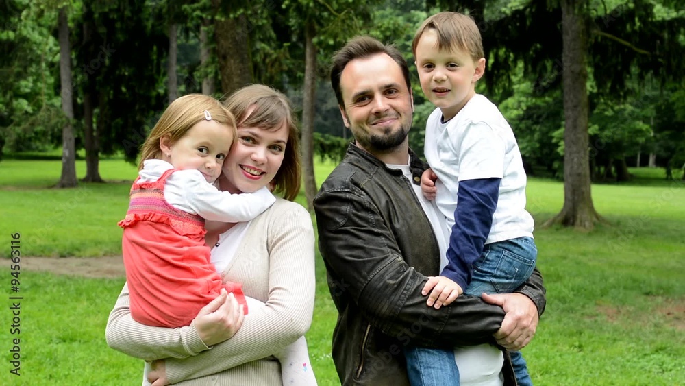 family (middle couple in love, cute girl and small boy) smile to camera in the park family (middle couple in love, cute girl and small boy) smile to camera in the park