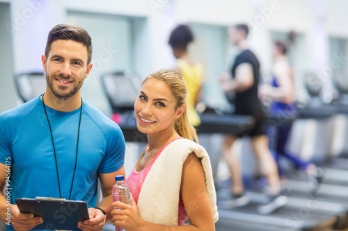 Obraz na płótnie Trainer and client discussing her progress