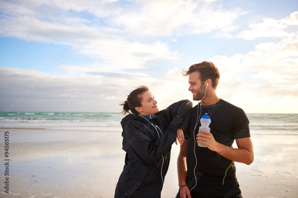 Friends in sports wear on the beach for a morning run