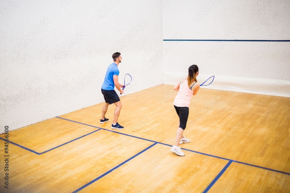 Couple playing a game of squash