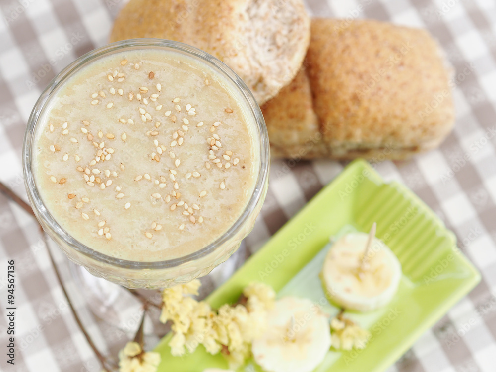 Soy milk smoothie with banana garnished with sesame seeds