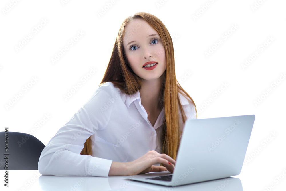 Young business woman using a laptop computer on the table isolat Young business woman using a laptop computer on the table isolat