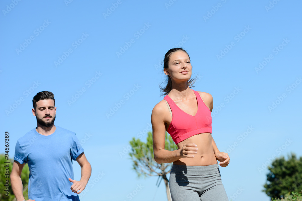 young healthy couple running outdoor in summer during a fitness exercise young healthy couple running outdoor in summer during a fitness exercise
