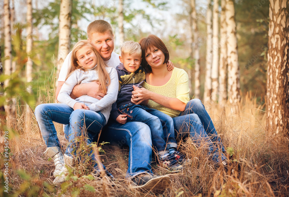 Radiant family sitting in the park Radiant family sitting in the park