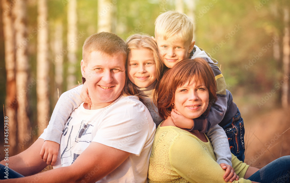 Radiant family sitting in the park