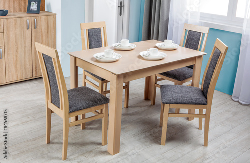 Simple wooden dinning table and chairs in interior - studio ambi