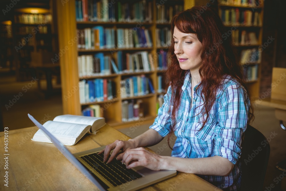 Mature student studying in library Mature student studying in library