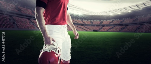 Composite image of american football player holding his helmet © vectorfusionart