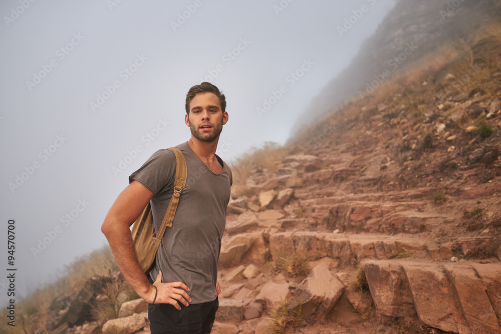 Young man on a rocky mountain nature trail Young man on a rocky mountain nature trail