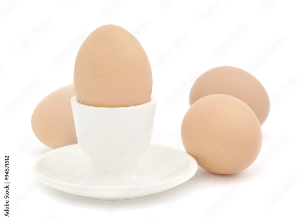 Egg in an egg cup and three eggs Egg in an egg cup and three eggs