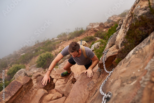 Hiker navigating some rocks on a mountain path