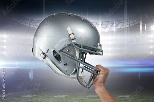 American football helmet against stadium