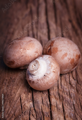 Fresh brown mushrooms on rustic wood