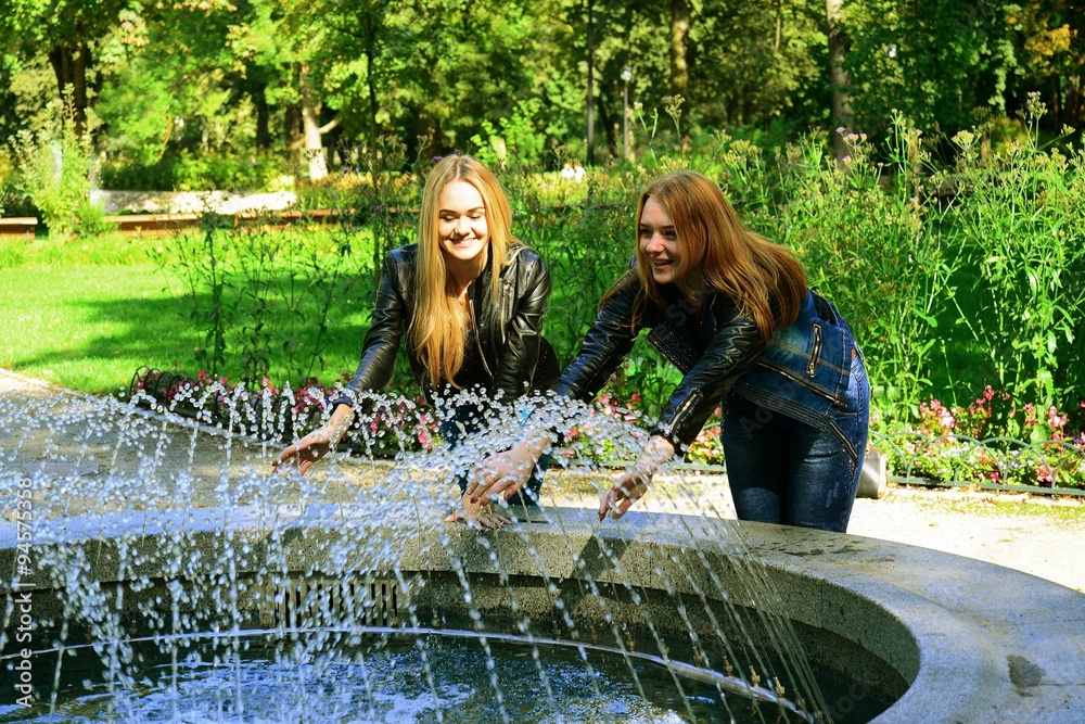 Two girls in Vilnius town Bernardinu garden on autumn
