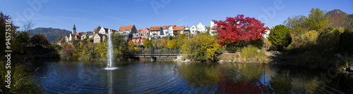 panorama of city frohnleiten,in styria,austria.autumnal colored trees and blue sky in october