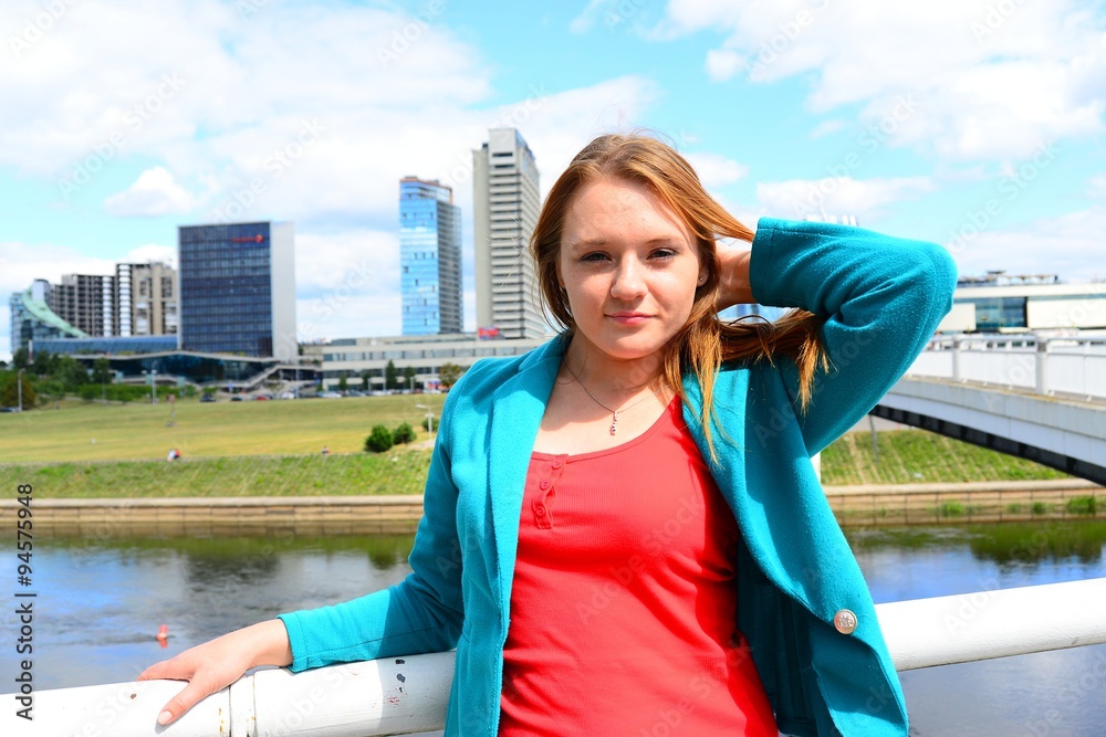 A girl in the city and blue sky and clouds background