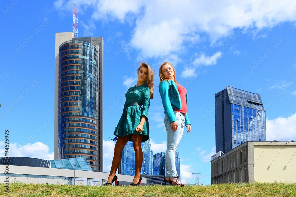 Two girls in blue sky and clouds background