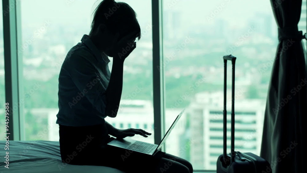 Young businesswoman having head pain during working on laptop in hotel room
Young businesswoman having head pain during working on laptop in hotel room