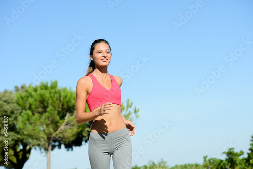 beautiful and healthy fitness young woman running outdoor during summer