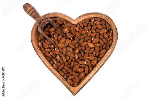 Salted almond on the wooden plate isolated.
