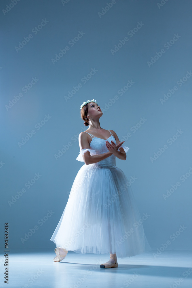 Naklejka premium Portrait of the ballerina on blue background