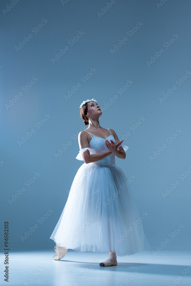 Portrait of the ballerina on blue background