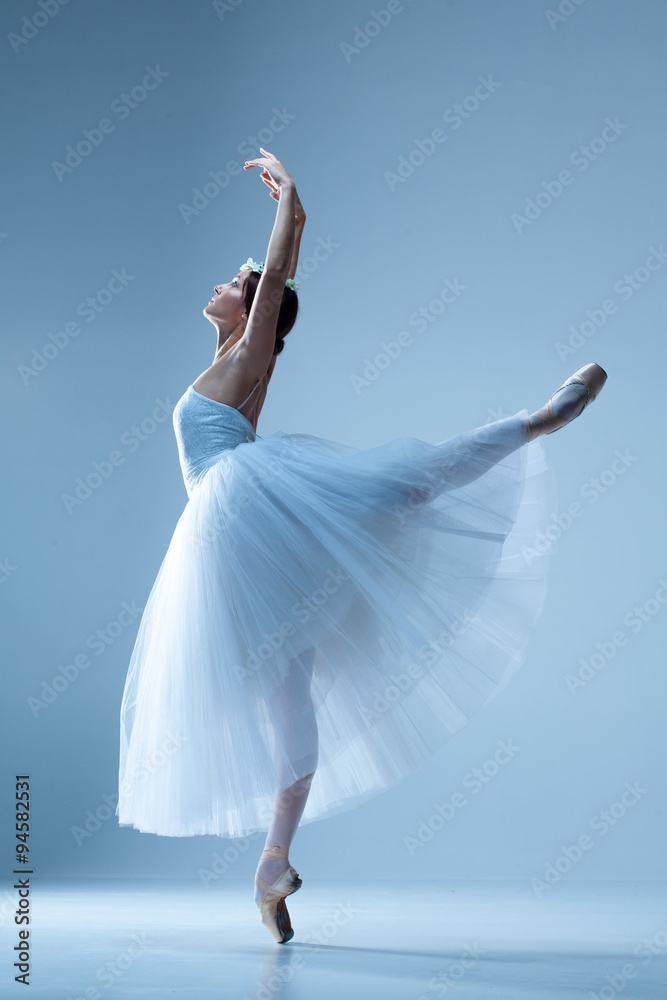 Fototapeta premium Portrait of the ballerina on blue background
