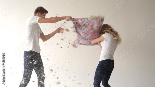 Young couple fighting pillows 