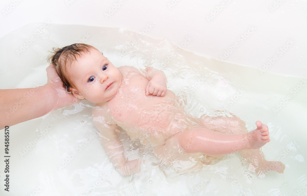 Newborn baby girl taking a bath Newborn baby girl taking a bath
