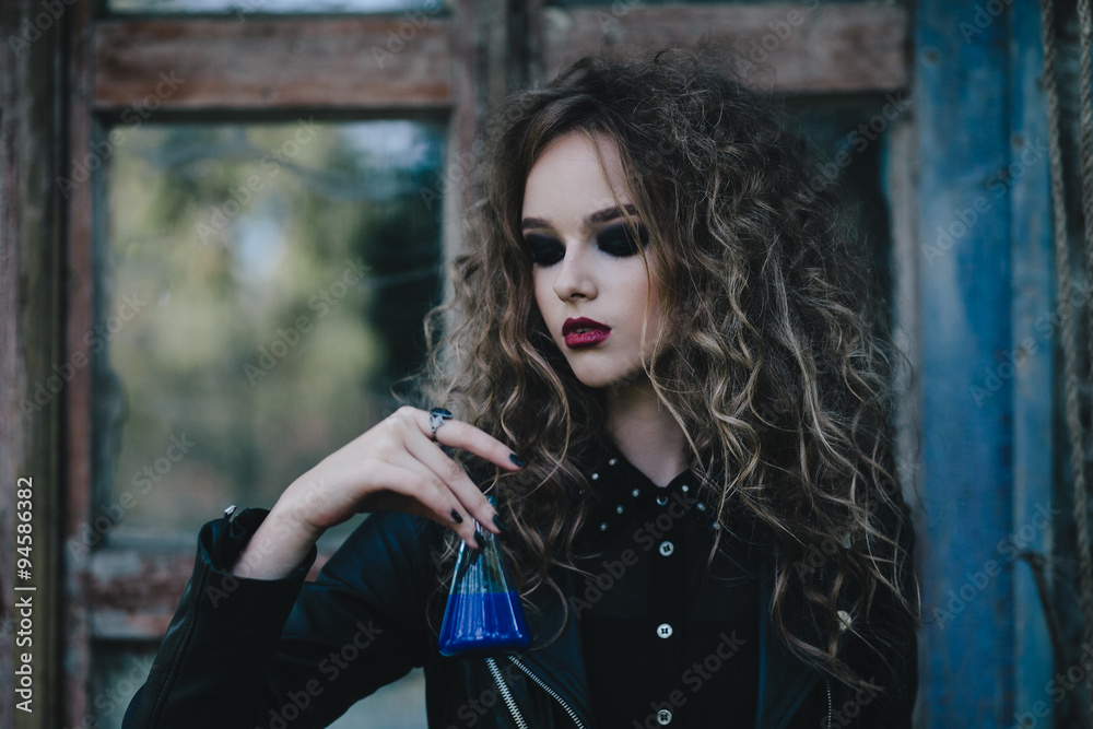 Fototapeta premium Vintage witch with elixir in hand