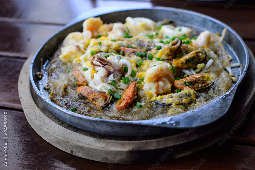 Crisp fried oyster pancake in hot plate Crisp fried oyster pancake in hot plate