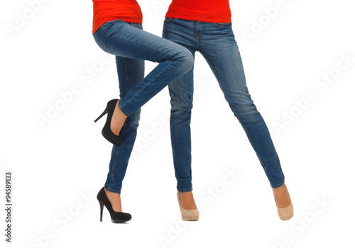 close up of two women legs in jeans