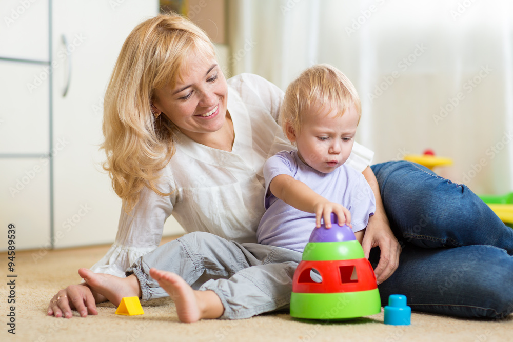 Obraz premium mother and her child playing with colorful logical toy