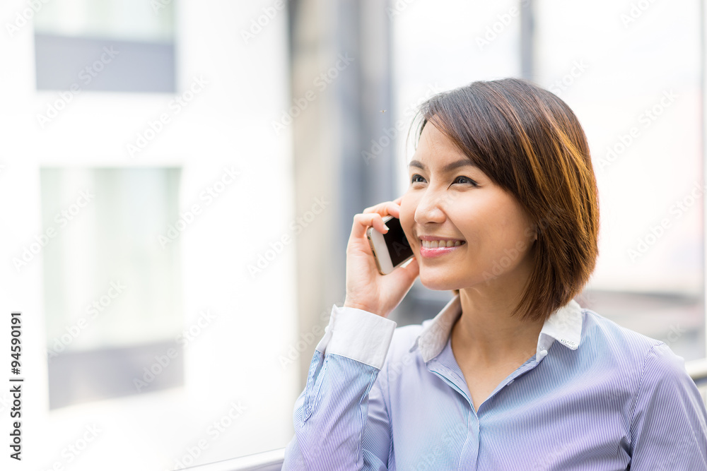 Asian businesswoman using mobile phone at office Asian businesswoman using mobile phone at office