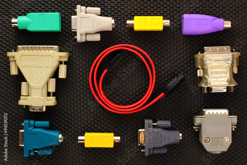 Different computer connectors and adapters on black background photo