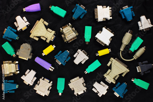 different pc connectors and adapters on black background photo