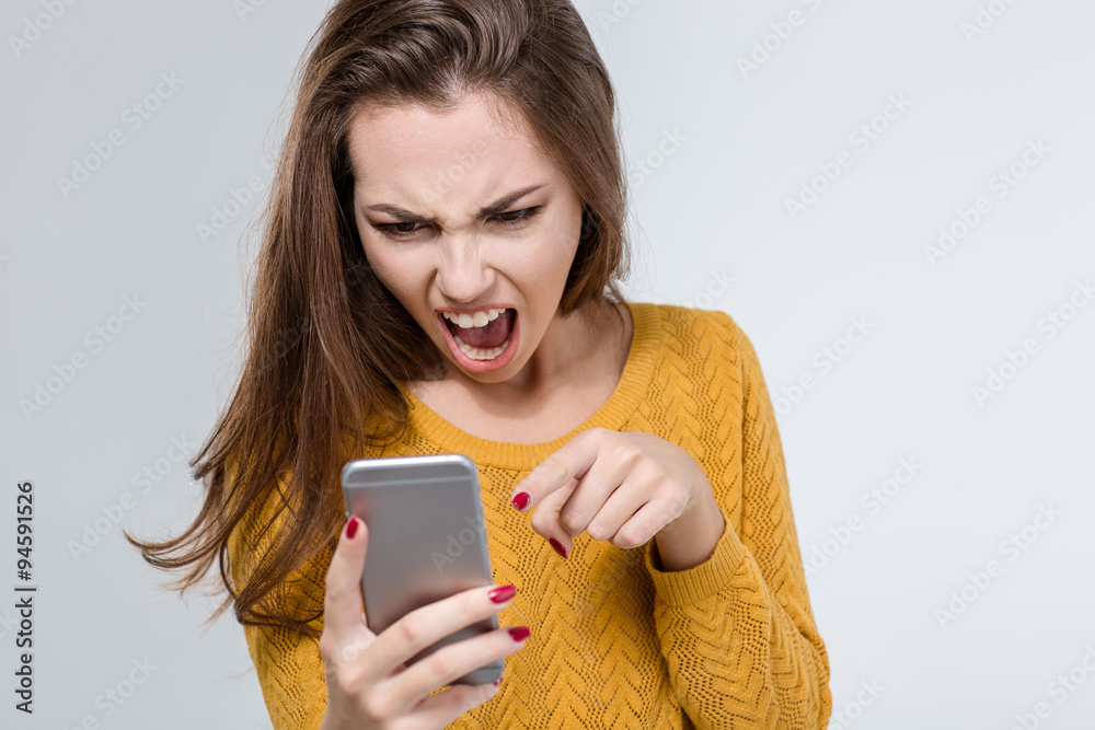 Angry woman screaming on the phone Angry woman screaming on the phone