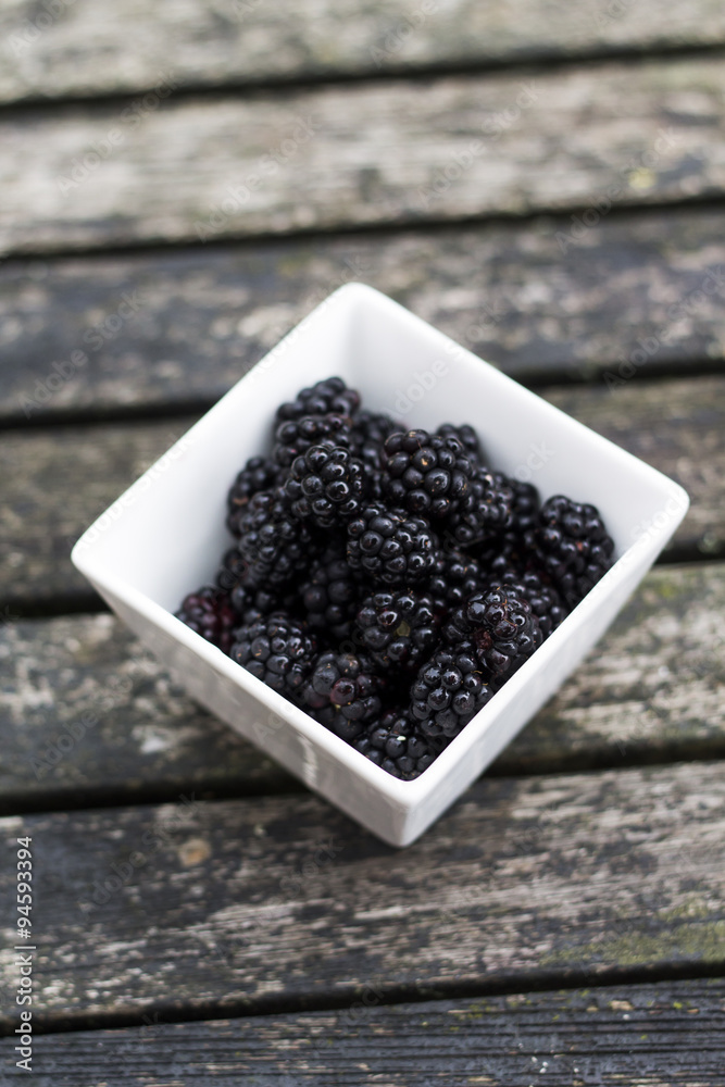 Blackberries in a square bowl on the garden table. Blackberries in a square bowl on the garden table.