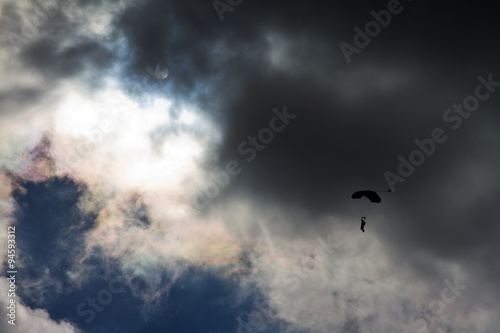 Parachute backlit against a ominous cloudy sky