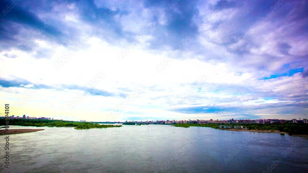 Timelapse of moving Of clouds on the coastline in the sky.View on Novosibirsk from the bridge Timelapse of moving Of clouds on the coastline in the sky.View on Novosibirsk from the bridge